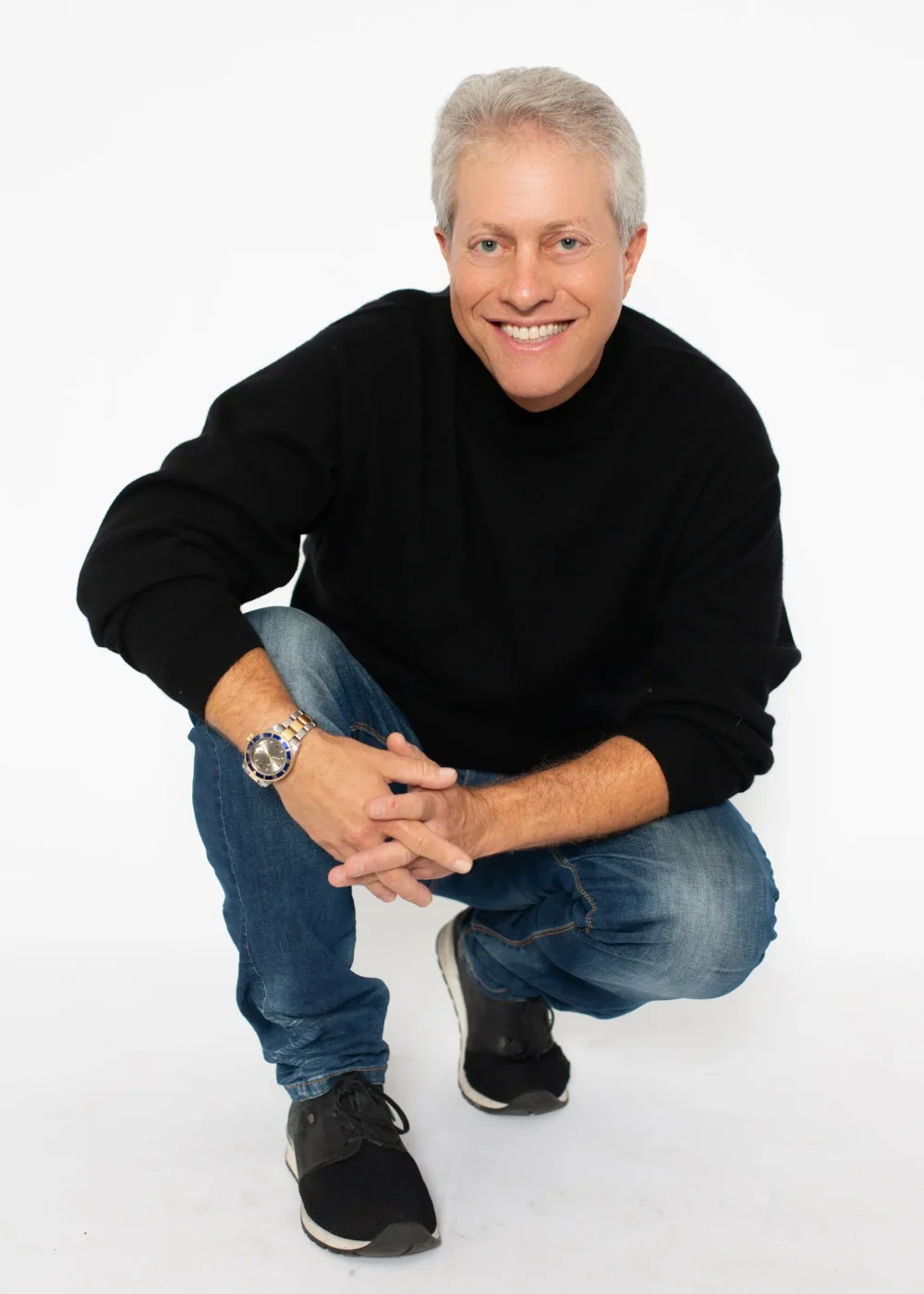 Scott Shimberg squatting in jeans PNG